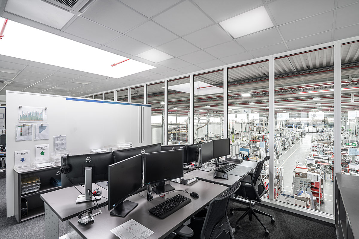 Multi-storey hall office with glass walls inside